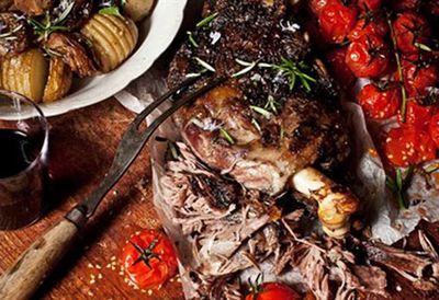 Slow-roasted greek lamb with tomatoes, onions and hasselback potatoes
