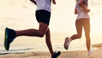 Two people running near beach.