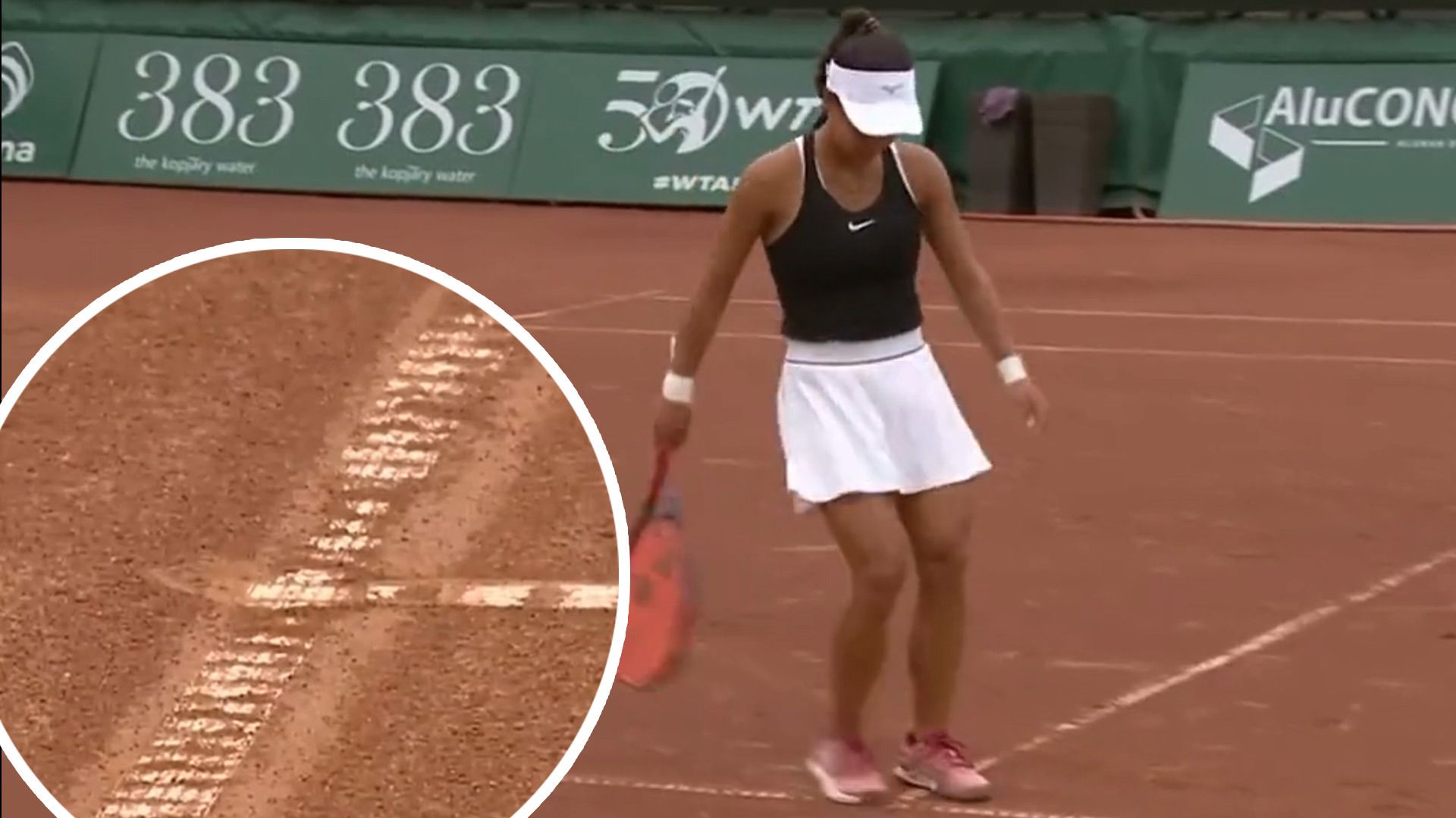 Amarissa Toth rubs out the mark where Shuai Zhang alleges her ball landed.