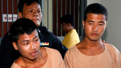 Zaw Lin (right) and Wai Phyo are escorted by a Thai police officer after they were sentenced to death.