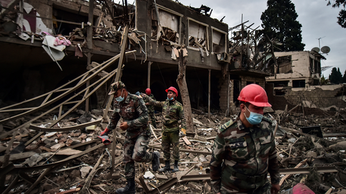  In this Oct. 11, 2020, file photo, Azerbaijani soldiers and firefighters search for survivors after rocket fire overnight by Armenian forces in a residential area in Ganja, Azerbaijan's second-largest city, near the border with Armenia. 