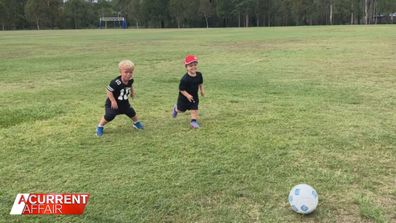 Floyd Morley and a friend playing soccer.