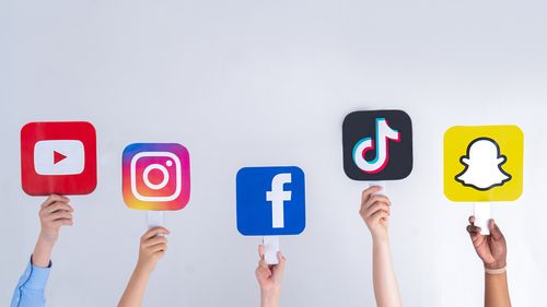 Teenagers hands hold social media signs in their hands: Youtube, Snapchat, Instagram, Tiktok, Facebook. Teenagers addicted to new technology trends - concept of youth, technology, social and friendship. Turkey, Istanbul, May 29, 2022.
