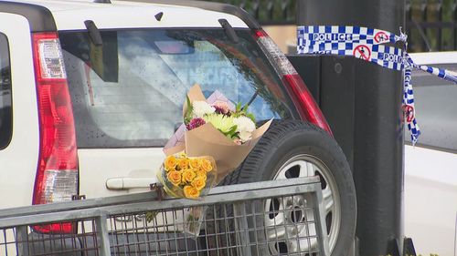 Floral tributes at the scene where a NSW paramedic was stabbed.