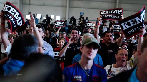 Brian Kemp supporters cheer on the Republican governor.