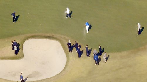 Donald Trump, right, Japanese Prime Minister Shinzo Abe, left, and Japanese golfer Hideki Matsuyama, centre in blue, play golf at the Kasumigaseki Country Club. (AAP)