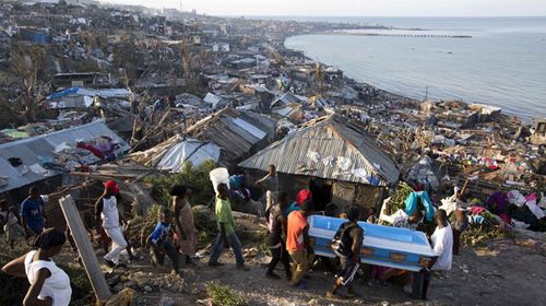 A group carry a coffin amid devastation in Haiti. (AP)
