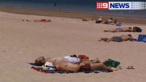Beachgoers take advantage of the heat in Adelaide, with temperatures set to top 42C in the city today. (9NEWS)