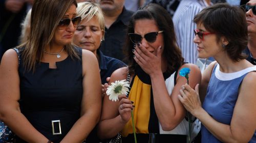 Clutching flowers, many broke down in tears as they stepped onto Las Ramblas.