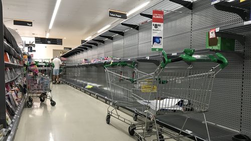 A supermarket in Double Bay with bare shelves as shoppers prepare for the worst.