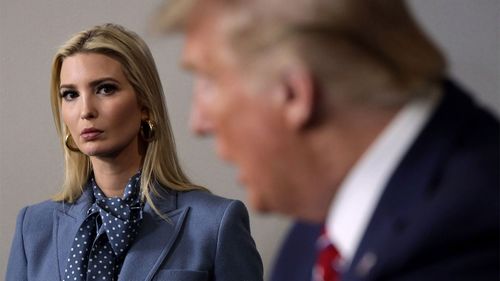 President Donald Trump speaks as his daughter and senior adviser Ivanka Trump looks on.