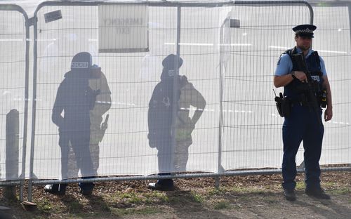 Police stand guard at the funeral of a father and son allegedly killed by a 28-year-old Australian man. (AAP Image/Mick Tsikas) 