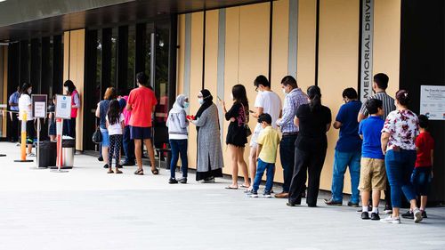 Parents and children line up for vaccines in Granville in Sydney's west.