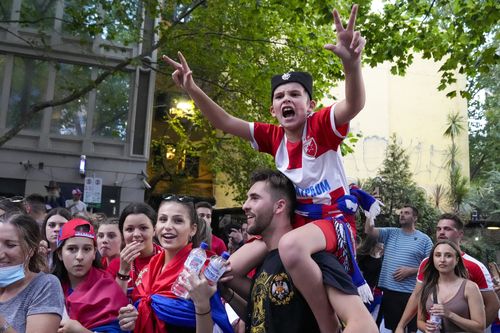 Novak Djokovic fans outside an immigration detention hotel where Serbian Novak Djokovic is confined in Melbourne, Australia, Monday, Jan. 10, 2022. 