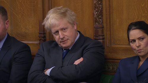 Boris Johnson, her former Foreign Secretary turned no-deal nemesis, watches on from the backbenches.