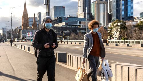 Pedestrians walk away from the central business district in Melbourne.