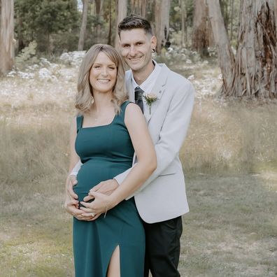 Rachel Bailey and her partner pose together after announcing they were expecting.