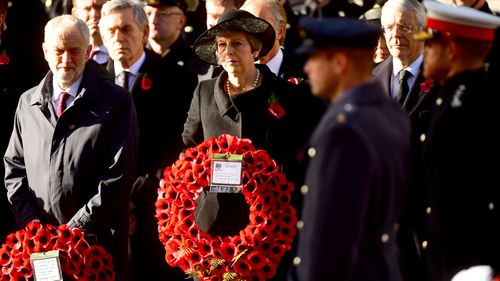 Labour leader Jeremy Corbyn and Prime Minister Theresa May watch as the Royal family lay wreaths during the remembrance service at the Cenotaph memorial in Whitehall, central London.