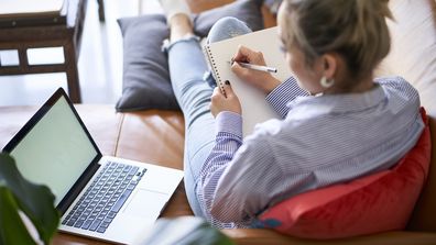 work from home flexible work arrangements laptop sitting on couch woman