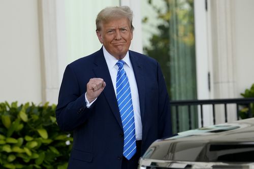 Former President Donald Trump pumps his fist as he arrives for a GOP fundraiser, Saturday, April 6, 2024, in Palm Beach, Florida