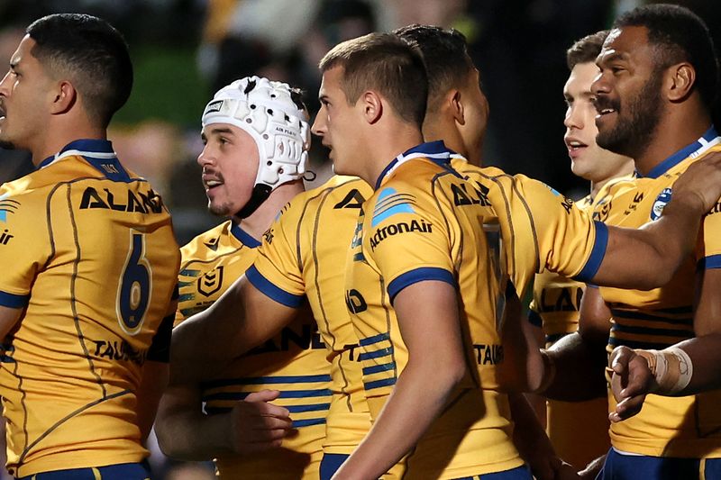 Maika Sivo of the Eels celebrates with teammates after scoring a try against the Manly Sea Eagles.