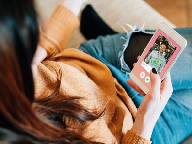 Young woman using dating app on phone