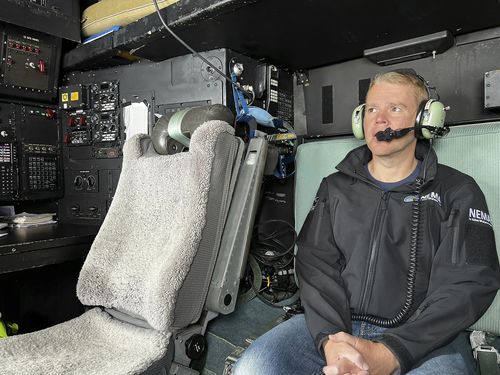 New Zealand's Prime Minister Chris Hipkins sit in a military plane Saturday, Jan. 28, 2023  bound for Auckland to assess the rain and flooding damage. 