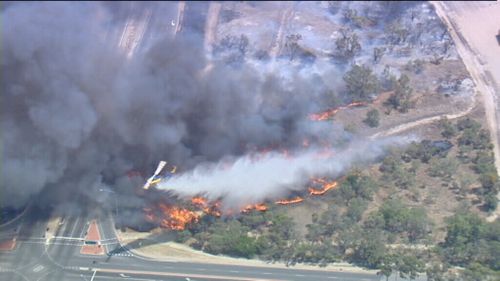Firefighters are desperately trying keep the fire back. (9NEWS)