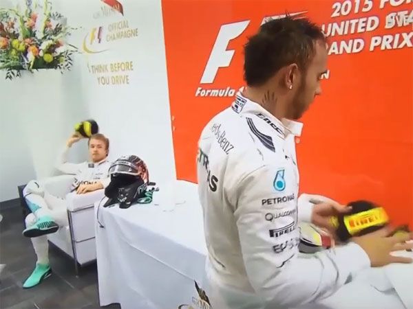 Nico Rosberg throws a hat at Lewis Hamilton. (Supplied)