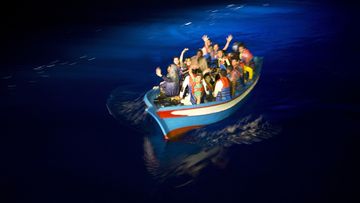 A wooden boat carrying migrants, not the boat mentioned in this story, attempts to cross into Europe.