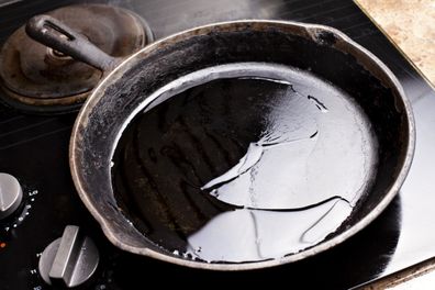 cast iron pan on stove with oil