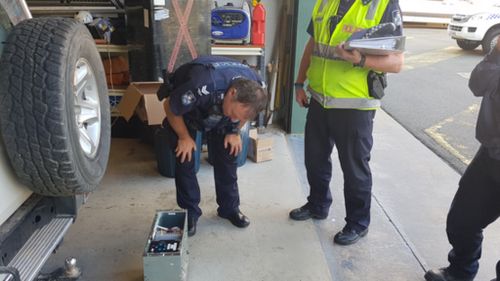 RES officers inspect the radio terminal. (Queensland Police)