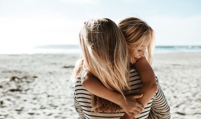 Mum with daughter on a beach