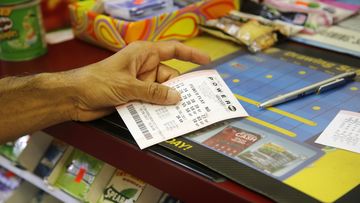 A customer buys a Powerball ticket, Thursday, June 8, 2017, in Chicago. The Powerball jackpot has grown up to $435 million, after more than two months without a winner. The jackpot for Saturday night&#x27;s drawing would tie for the nation&#x27;s 10th largest lottery prize. (AP Photo/G-Jun Yam)