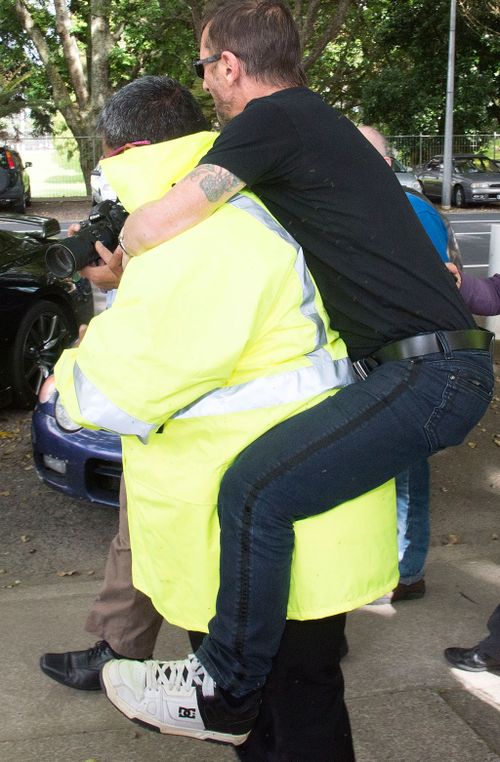 Phil Rudd employs and unusual escape method after his appearance in Tauranga High Court. (AFP)