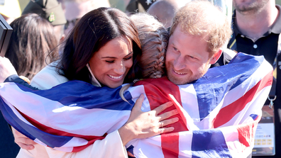     Prince Harry, Duke of Sussex and Meghan, Duchess of Sussex hug Team England's Lisa Johnston on the second day of the 2020 Invictus Games in The Hague on April 17, 2022 in The Hague, Netherlands.  (Photo by Chris Jackson/Getty Images for the Invictus Games Foundation)