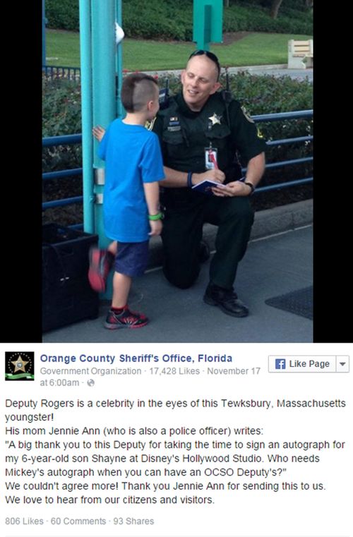 Boy seeks autograph at Disney World from police officer.  (Social Media)