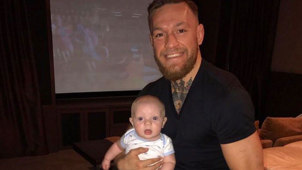 UFC lightweight champion Conor McGregor watches fights with son Conor Jr