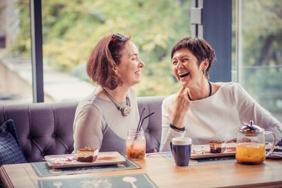 Middle-aged women having coffee at a cafe. Female friends at a cafe.