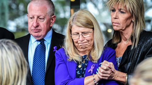 Mark and Faye Leveson with a friend outside court today. (AAP)