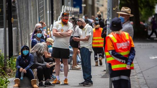 People queue for a COVID-19 test at St Vincent's Hospital in Fitzroy.