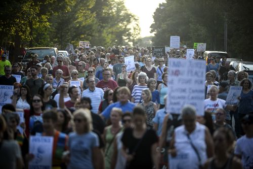 Hundreds walked from the site of Justine's fatal shooting to Plaissance Park in the suburb of Beard, Minneapolis. Picture: AAP