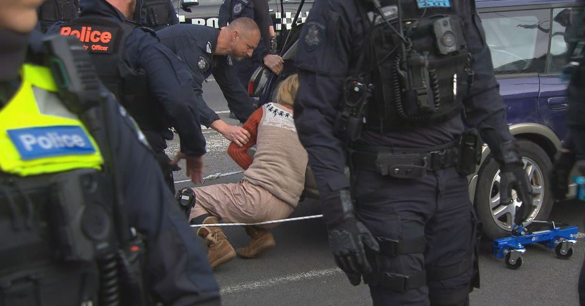 Woman chains herself to car during Melbourne protests