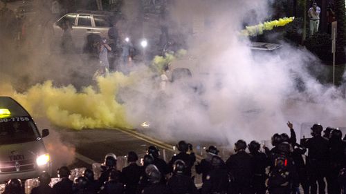 Riot police use tear gas on anti-Trump protesters. (Getty)