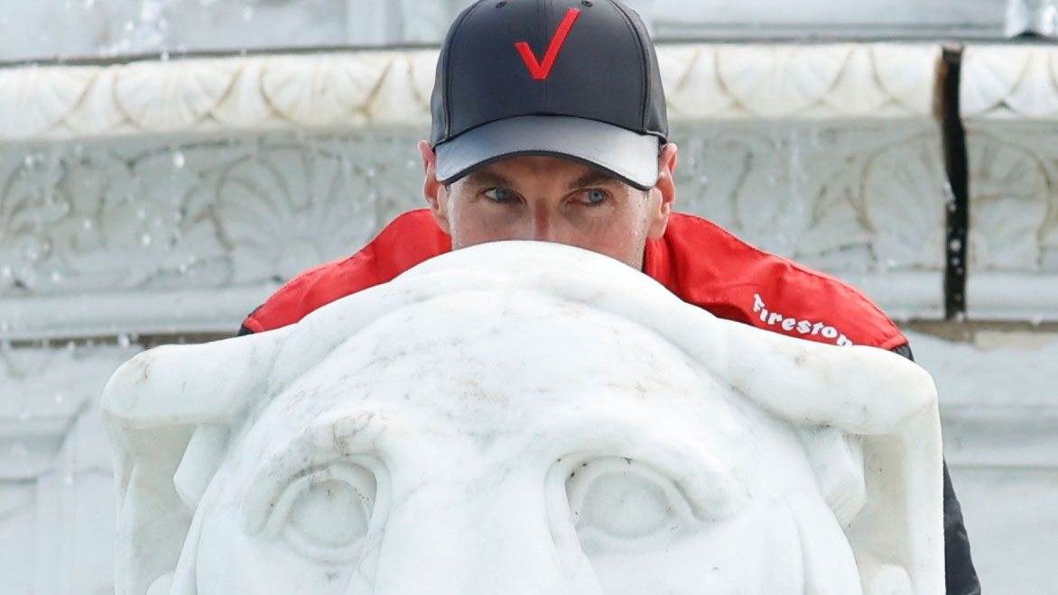 Will Power sits on and peers over a Lion Statue in the James Scott Memorial Fountain after winning the race at Isle Park. Brian Spurlock/Icon Sportswire via Getty Images