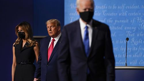 In this photo from October last year, First lady Melania Trump, left, and President Donald Trump, centre, remain on stage as Democratic presidential candidate former Vice President Joe Biden, right, walks away at the conclusion of the second and final presidential debate at Belmont University in Nashville.