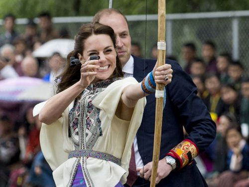The Duchess takes aim as Prince William looks on. (AFP)
