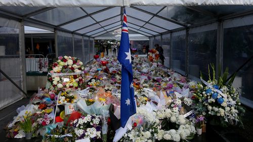 Flower tributes are seen at the edge of Westfield Bondi Junction
