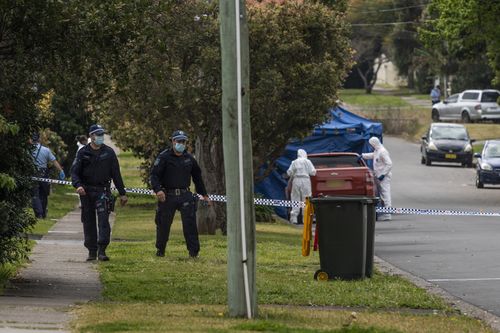 Police investigators working with blue tent and police tape after an 18-year-old man was stabbed in Blacktown last night.