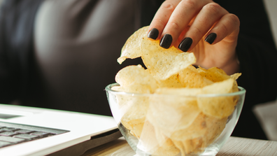 Woman reaching for potato chips